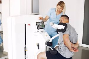 Paciente y fisioterapeuta usando tecnología en fisioterapia.